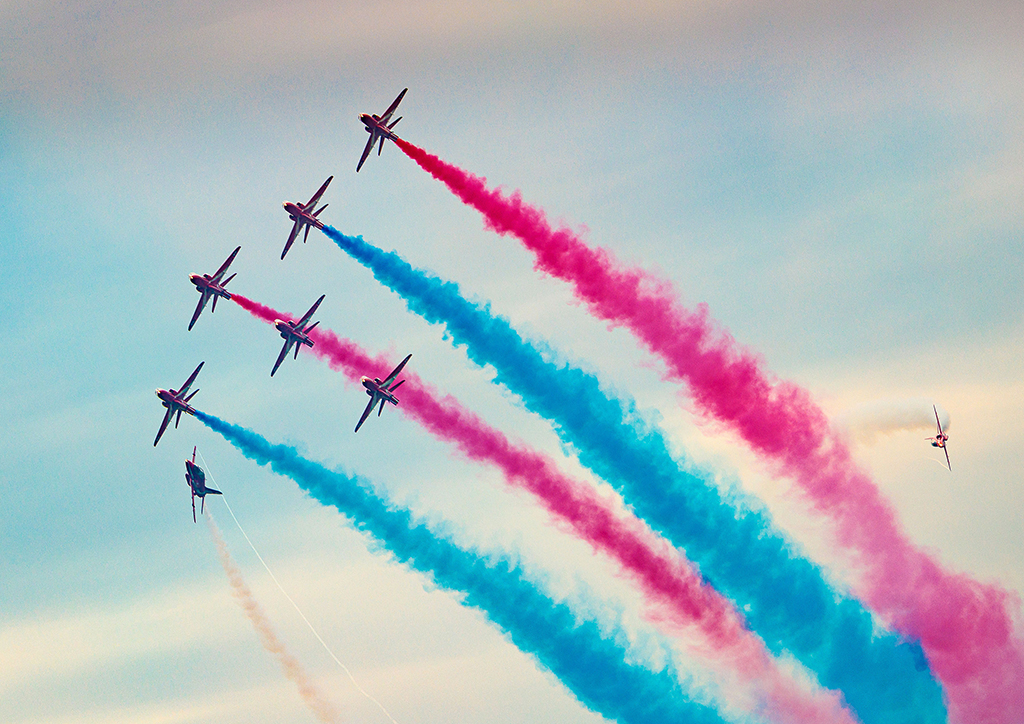 The Royal Air Force Red Arrows Display Team streak across the sky while performing their signiture 'Corkscrew' formation.